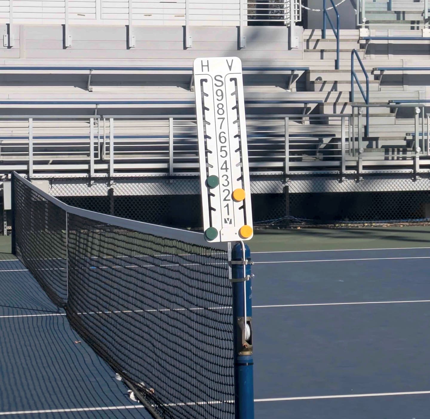 Tennis net and court scoreboard at a New York City court