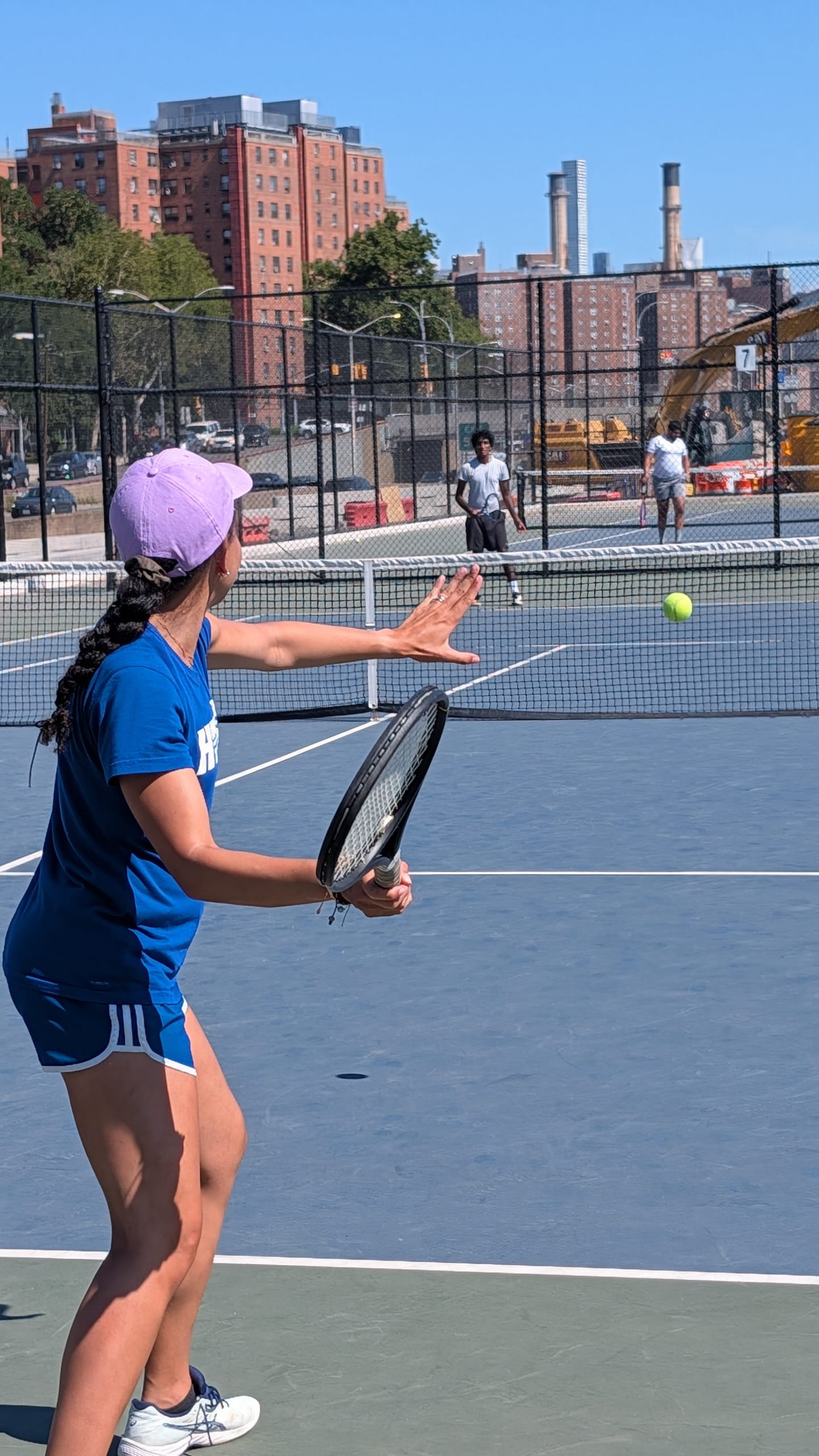 Ana reaching for a ball at the net during a doubles game