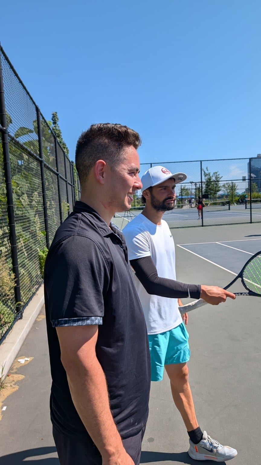Coach Ghila alongside a Hydracourt player on court