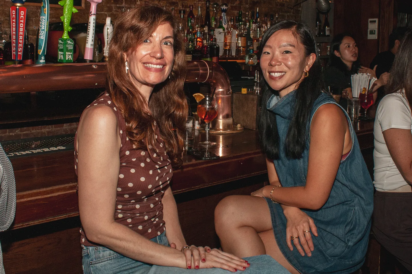 Two guests enjoying the watch party at the bar