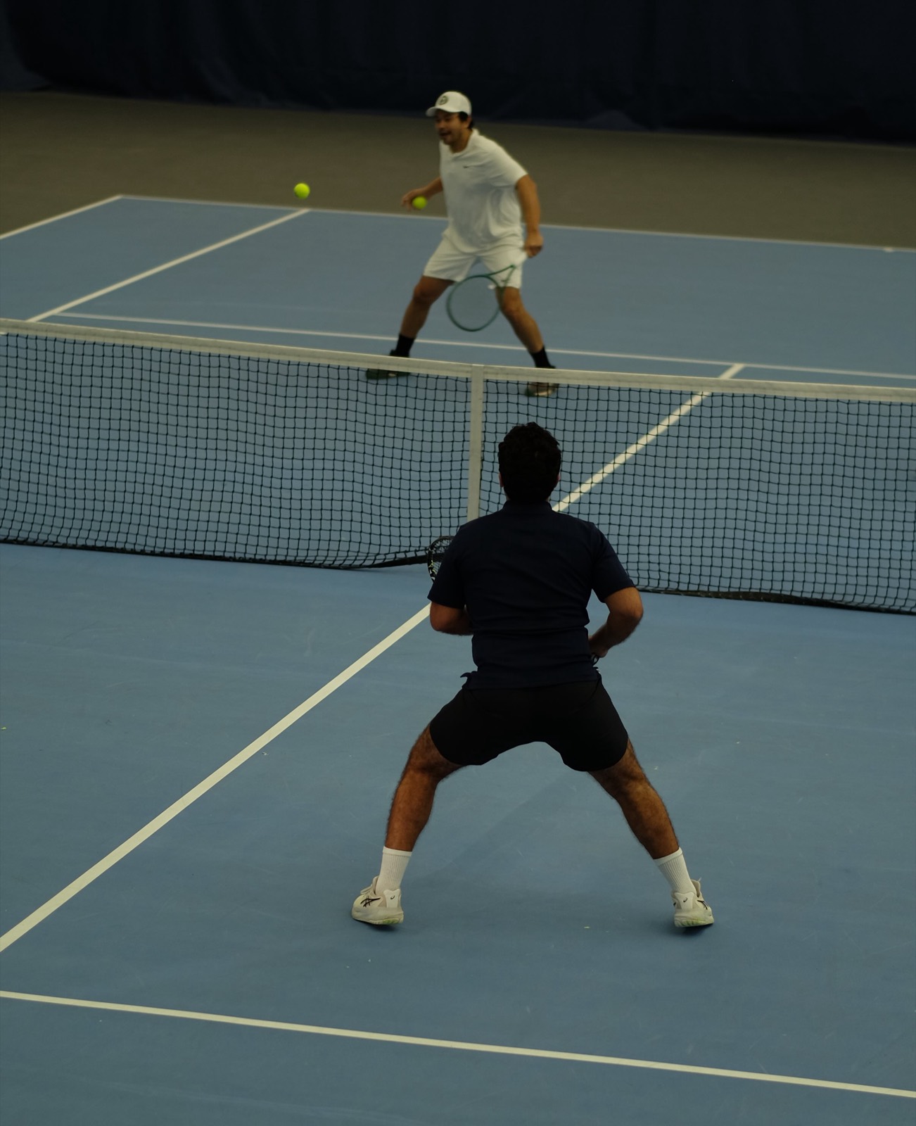 Two players competing on a New York City tennis court